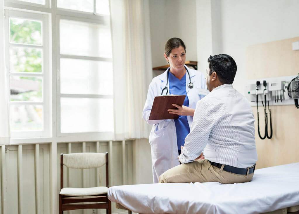 Doctor standing in front of patient